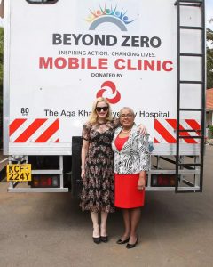 Pop icon Madonna and first lady Margaret Kenyatta pose for a photo next to a Beyond Zero mobile clinic van.