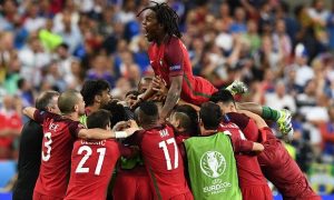 Portugal's Renato Sanches jumps on teammates after Eder scores.