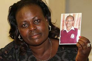 Mrs Sally Chepngetich Bett with a picture of her daughter Emily who died of meningitis. She was a student at Our Lady of Mercy Secondary School in Nairobi. Photo / Daily Nation
