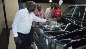 Zabron Mathenge (in white), inspects his new limousine
