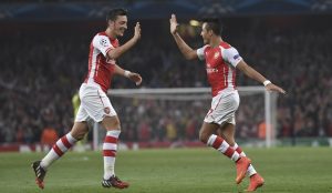 Arsenal's Alexis Sanchez, right, celebrates after scoring against Galatasaray with his teammate Mesut Ozil during the Champions League Group D soccer match between Arsenal  and Galatasaray , at the Emirates Stadium in London, on Wednesday, Oct 1, 2014. (AP Photo/ Tim Ireland)